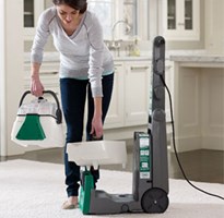 Woman using a Bissell Carpet Cleaner Rental